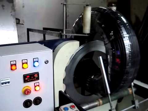 Machine for wrapping coils, pipes, tyres, and binding wire. Machine for wrapping coils, pipes, tyres, and binding wire.