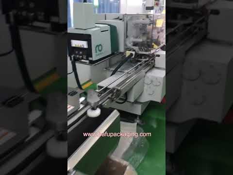 Compact chocolate packaging machine with fold wrapping capability.